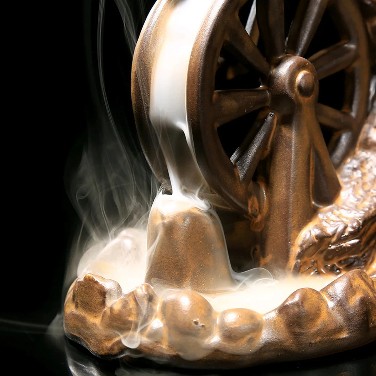 Close-up of the water wheel, with smoke pouring downwards
