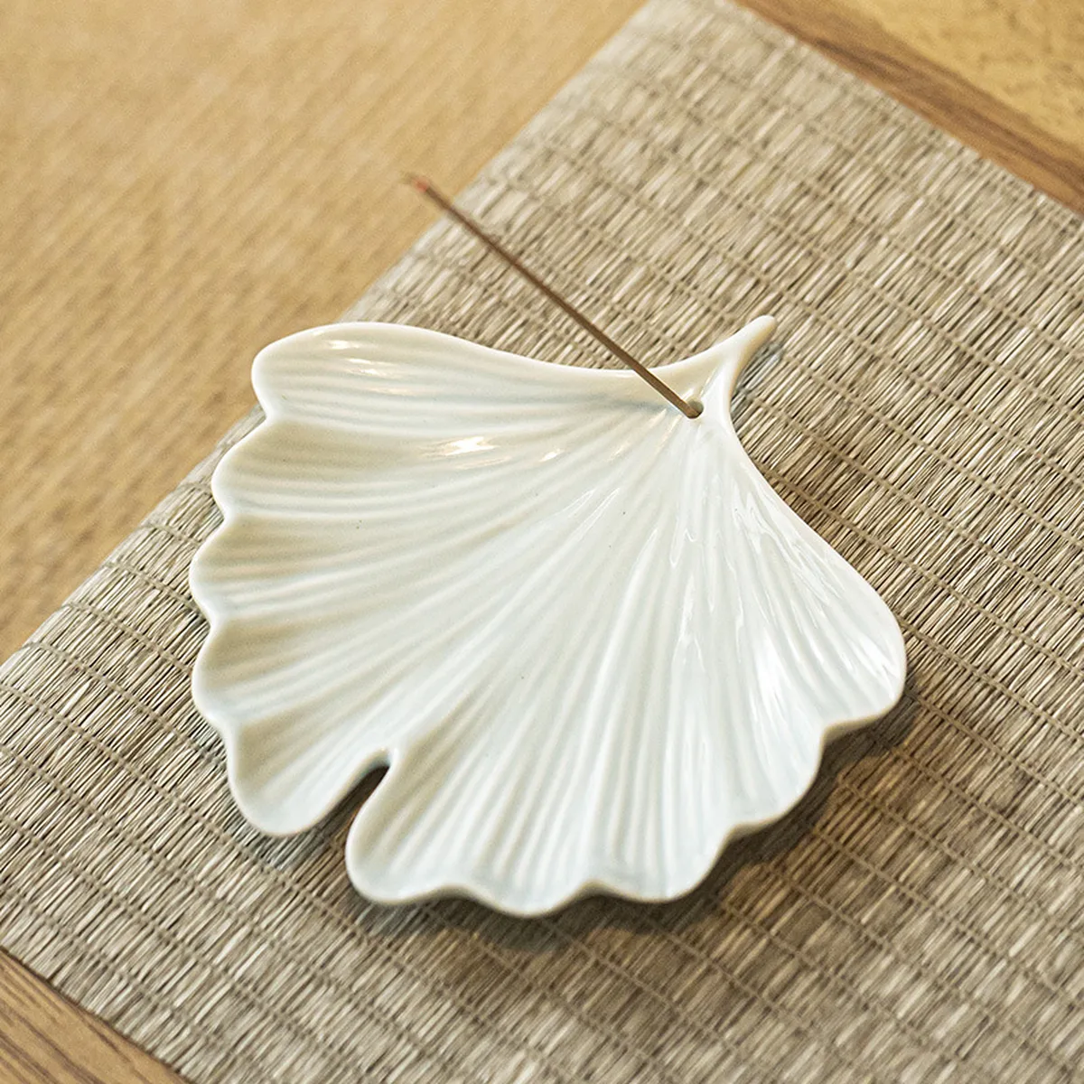 Celadon ginkgo leaf incense holder with a stick in the stem