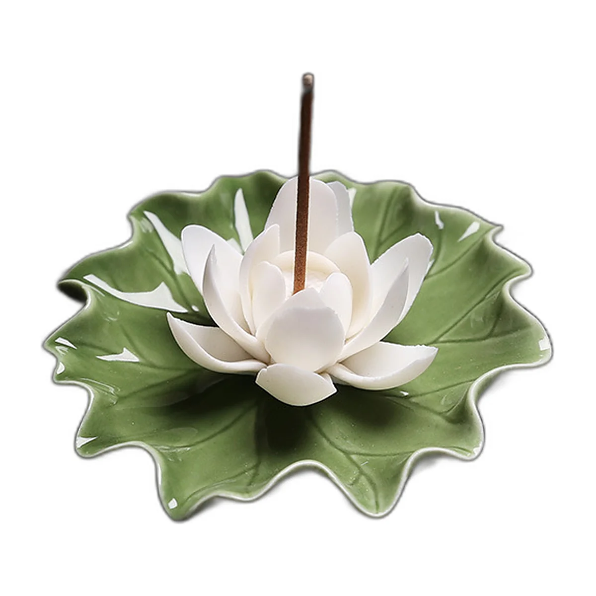 White porcelain lotus incense holder on a green leaf