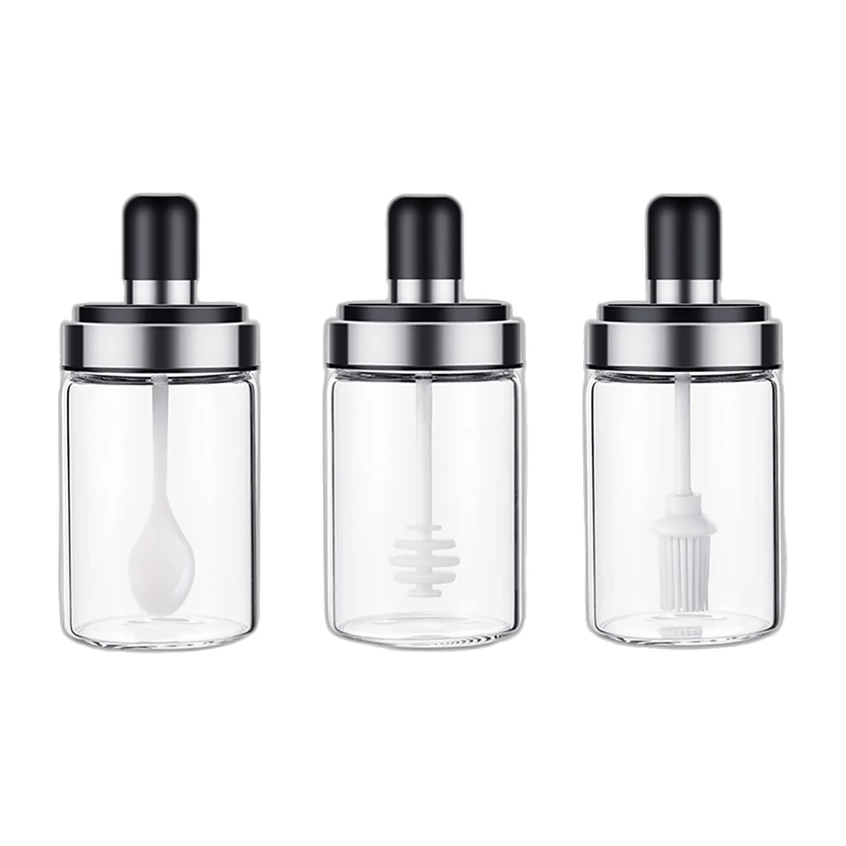 Three glass jars with black lids: spoon, honey dipper and brush