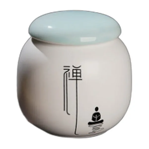 Small white ceramic jar with zen character and celadon lid