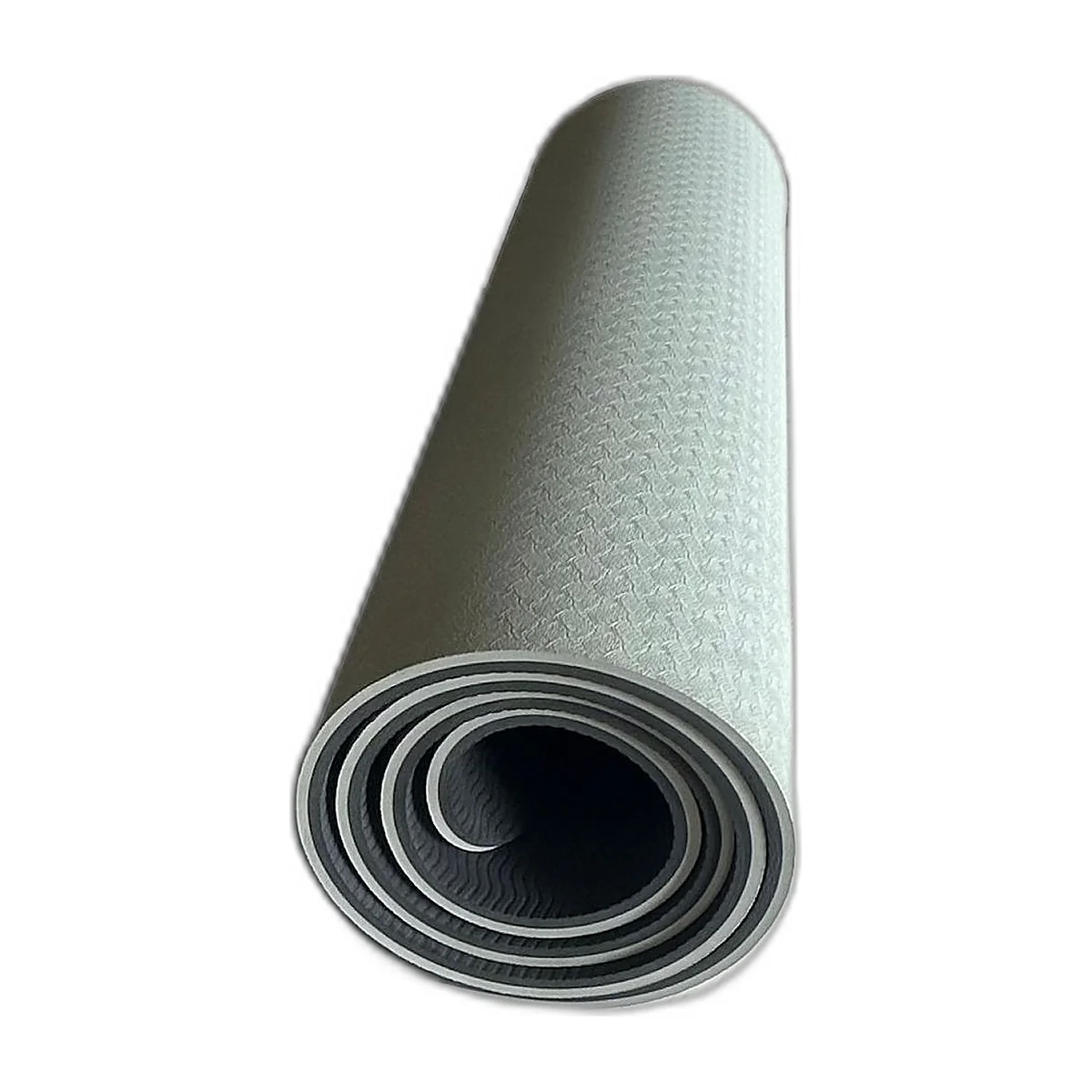 Grey and black TPE yoga mat rolled up, textured side visible