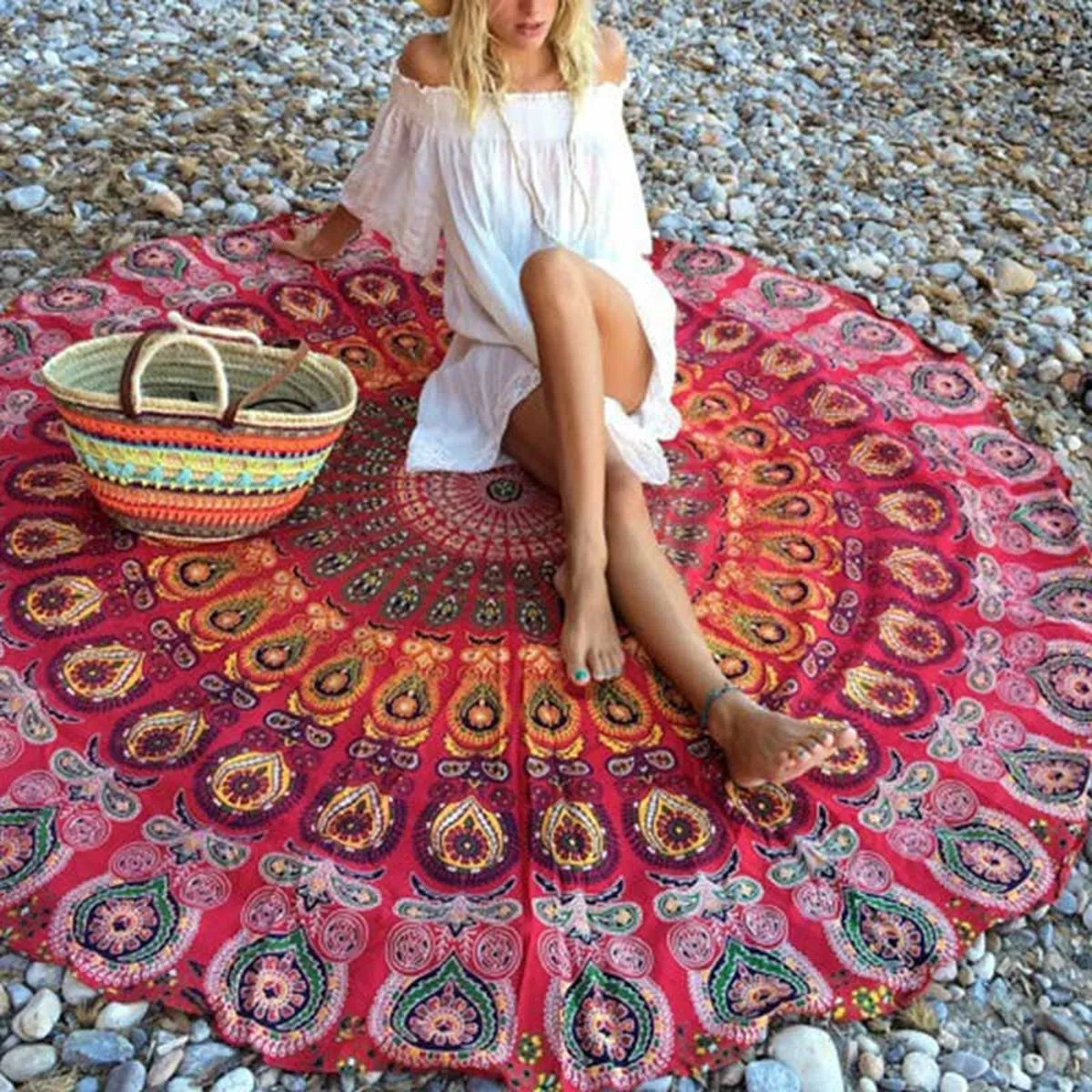 Red round mandala throw spread out on pebbles
