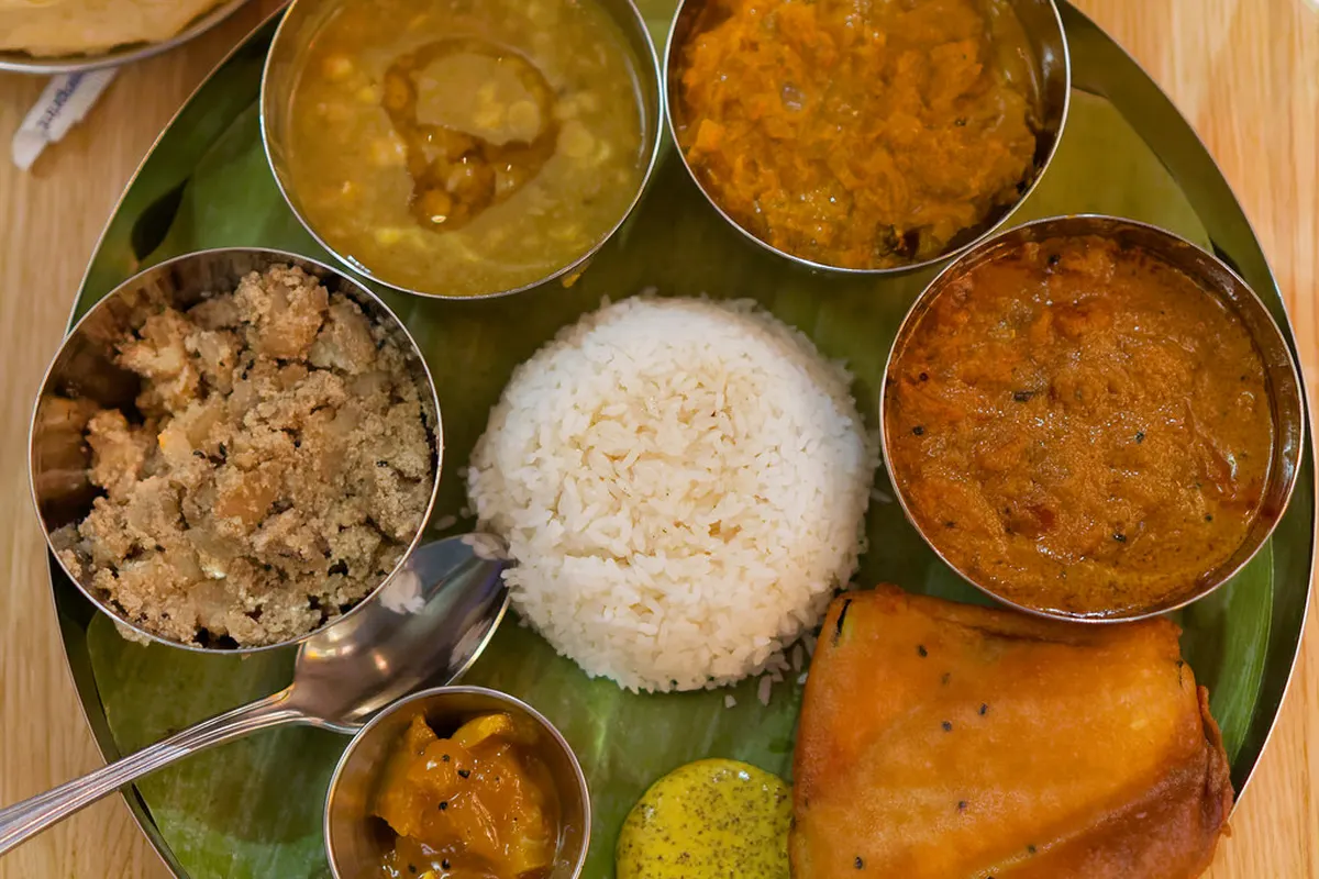 Vegetarian thali: rice, dal, vegetables and chutneys in small bowls